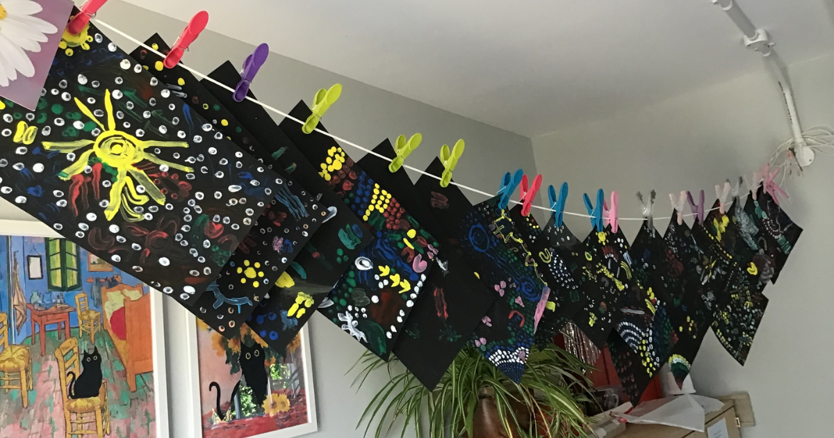 Australia-inspired artwork hung in a line. 